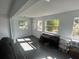 The living room features plenty of natural light from the surrounding windows at 300 S Highland Ave, Tarpon Springs, FL 34689