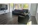 Bright living area with stylish furniture, including a leather sofa set and television at 300 S Highland Ave, Tarpon Springs, FL 34689