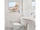 Modern bathroom with white marble-style tile, geometric tile floor and pedestal sink at 3124 9Th N Ave, St Petersburg, FL 33713