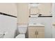 Classic bathroom featuring white tiles with black trim, a toilet, and a vanity with storage at 3124 9Th N Ave, St Petersburg, FL 33713