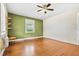 Bedroom with hardwood floors, ceiling fan, and a bright, windowed wall at 3124 9Th N Ave, St Petersburg, FL 33713