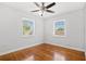 Bright bedroom featuring hardwood floors, ceiling fan, and two sunny windows at 3124 9Th N Ave, St Petersburg, FL 33713