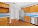 Modern kitchen featuring stainless steel appliances, wooden cabinets, and a tile backsplash at 3124 9Th N Ave, St Petersburg, FL 33713