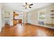 Open living room with hardwood floors, ceiling fan, and an opening to the kitchen area at 3124 9Th N Ave, St Petersburg, FL 33713