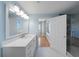 The bathroom has a glass-enclosed shower, a white vanity, and blue walls at 345 Bayshore Blvd # 1502, Tampa, FL 33606