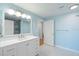 Bathroom with modern vanity, walk-in shower, and blue walls at 345 Bayshore Blvd # 1502, Tampa, FL 33606