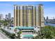 High-rise condo building featuring a pool, covered parking and views of the city skyline at 345 Bayshore Blvd # 1502, Tampa, FL 33606