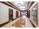Long, bright hallway with marble floors, wood trim, and several doorways leading to different areas at 345 Bayshore Blvd # 1502, Tampa, FL 33606