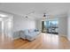 Bright living room featuring hardwood floors, sliding doors to balcony, and a comfortable gray sofa at 345 Bayshore Blvd # 1502, Tampa, FL 33606