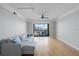 Bright living room featuring hardwood floors, sliding doors to balcony, and a comfortable gray sofa at 345 Bayshore Blvd # 1502, Tampa, FL 33606
