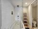 Bright bathroom with a tiled tub/shower combo, modern fixtures, and stylish ladder shelf at 350 Pinellas Bayway S # 2, St Petersburg, FL 33715
