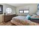 Charming bedroom featuring a round window, a dresser, and a stylish patterned bed at 350 Pinellas Bayway S # 2, St Petersburg, FL 33715
