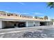 Exterior of a condo complex showcasing individual garages with vehicle parking in the driveway at 350 Pinellas Bayway S # 2, St Petersburg, FL 33715