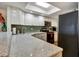 Bright kitchen featuring quartz countertops, white cabinets, and sleek black appliances at 350 Pinellas Bayway S # 2, St Petersburg, FL 33715