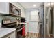 Well-appointed kitchen with stainless steel appliances and convenient washer/dryer setup at 350 Pinellas Bayway S # 2, St Petersburg, FL 33715