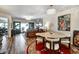 Open-concept living and dining area with elegant chandelier, modern furnishings, and sliding glass doors at 350 Pinellas Bayway S # 2, St Petersburg, FL 33715