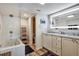Bright and modern main bathroom featuring double vanities, a soaking tub, and a glass-enclosed shower at 350 Pinellas Bayway S # 2, St Petersburg, FL 33715
