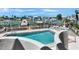 Sparkling waterfront pool boasts clear water, and serene view of boats docked along the waterfront at 350 Pinellas Bayway S # 2, St Petersburg, FL 33715