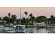 Peaceful waterfront view of houses and boats along a canal with palm trees in the background at 350 Pinellas Bayway S # 2, St Petersburg, FL 33715