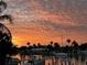 Scenic waterfront view featuring a colorful sunset, palm trees, and tranquil waters for a serene atmosphere at 350 Pinellas Bayway S # 2, St Petersburg, FL 33715