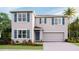 Charming two-story home with blue shutters, a two-car garage, and manicured landscaping at 35138 Valley Ridge Rd, Dade City, FL 33525