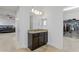 Elegant bathroom vanity with granite counters, dark wood cabinets, and access to the walk-in closet at 3615 W Kensington Ave, Tampa, FL 33629
