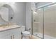 Bathroom features a shower with glass doors, granite counters and modern cabinets at 3615 W Kensington Ave, Tampa, FL 33629