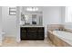 Elegant bathroom vanity with granite counters, dark wood cabinets, and access to the main bedroom at 3615 W Kensington Ave, Tampa, FL 33629
