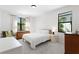 Inviting bedroom with bright windows and wood furnishings at 3615 W Kensington Ave, Tampa, FL 33629