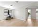 Well-lit bedroom with a large window, desk, chair, and light wood floors, perfect for work or relaxation at 3615 W Kensington Ave, Tampa, FL 33629