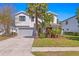 Beautiful two-story home with a well-manicured lawn and lush landscaping at 3615 W Kensington Ave, Tampa, FL 33629