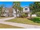 Lovely two-story home with a well-kept lawn and mature palm trees at 3615 W Kensington Ave, Tampa, FL 33629