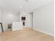 Bright hallway features wood floors, laundry closet, and neutral paint, creating a welcoming and functional space at 3615 W Kensington Ave, Tampa, FL 33629