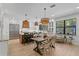 Bright kitchen featuring a large island, stainless steel appliances, and an adjacent dining area with decorative lighting at 3615 W Kensington Ave, Tampa, FL 33629