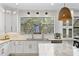 Gourmet kitchen featuring a large window, modern fixtures, and ample counter space at 3615 W Kensington Ave, Tampa, FL 33629