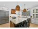 Gourmet kitchen features stainless steel appliances, a custom range hood, and a granite island with seating at 3615 W Kensington Ave, Tampa, FL 33629