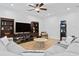 Cozy living room with plush seating, built-in bookshelves, and a large television at 3615 W Kensington Ave, Tampa, FL 33629