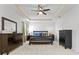 Spacious main bedroom with a ceiling fan, crown molding, and dark wood furniture offering a relaxing retreat at 3615 W Kensington Ave, Tampa, FL 33629