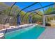 Inviting screened-in pool area with waterfalls and comfortable outdoor seating, perfect for entertaining at 3615 W Kensington Ave, Tampa, FL 33629