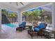 Relaxing outdoor patio with a beautiful pool and plenty of seating at 3615 W Kensington Ave, Tampa, FL 33629