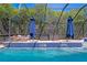 Inviting pool with waterfall feature and shade umbrellas at 3615 W Kensington Ave, Tampa, FL 33629
