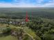 Aerial view of a home with a screened-in pool on a golf course, surrounded by trees at 3633 Cordgrass Dr, Valrico, FL 33596