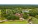 Aerial shot of the clubhouse, tennis courts, and surrounding lush landscaping at 3633 Cordgrass Dr, Valrico, FL 33596