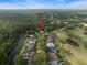 Aerial view of home near a golf course, nestled among trees and a pond at 3633 Cordgrass Dr, Valrico, FL 33596
