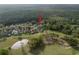 An aerial view of a home with a golf course nearby, nestled by mature trees at 3633 Cordgrass Dr, Valrico, FL 33596
