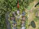 Aerial view of a home near a golf course and pond, surrounded by mature trees at 3633 Cordgrass Dr, Valrico, FL 33596