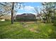 Wide view of the backyard and screened-in lanai overlooking a grassy yard at 3633 Cordgrass Dr, Valrico, FL 33596