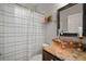 The bathroom includes a stylish bowl sink on granite countertops and a shower with a striped curtain at 3633 Cordgrass Dr, Valrico, FL 33596