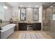 Bright bathroom featuring double vanity, soaking tub, and glass shower with modern fixtures at 3633 Cordgrass Dr, Valrico, FL 33596