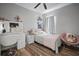 This bedroom features wood flooring, a vanity area and a comfortable bed at 3633 Cordgrass Dr, Valrico, FL 33596